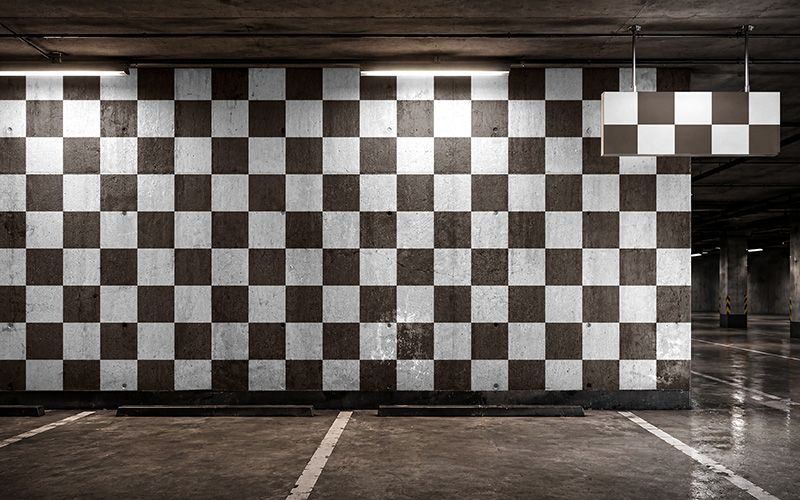 Editable wayfinding sign and wall mockup with concrete parking wall, hanging sign, smart object areas, and underground garage background.